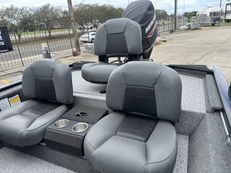 Slide: The Image of 2024 Tracker Pro 170 boat interior with gray seats and cup holders. - 11