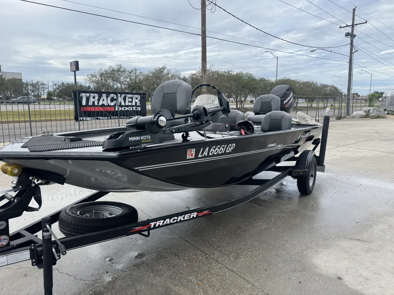 Slide: The Image of 2024 Tracker Pro 170 boat on trailer, displayed outdoors with Minn Kota motor. - 5