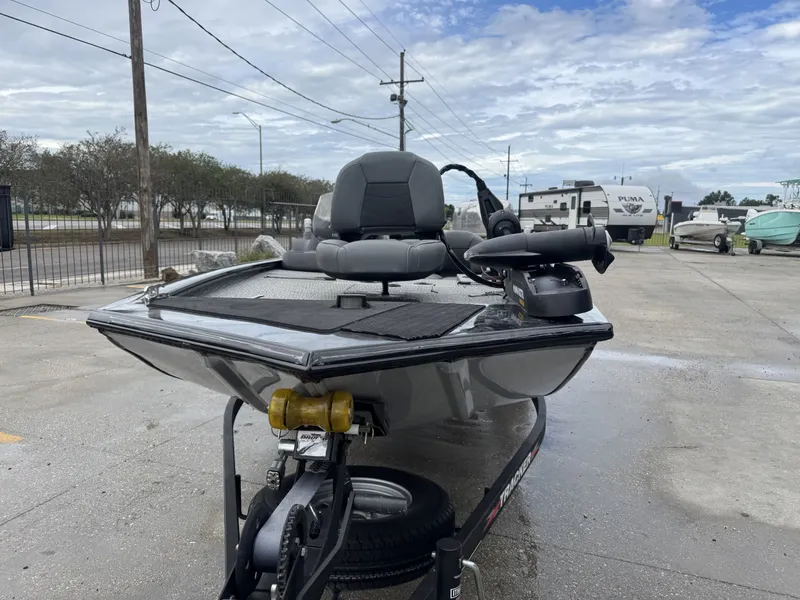 Slide: The Image of 2024 Tracker Pro 170 boat on trailer, parked outdoors under cloudy sky. - 6