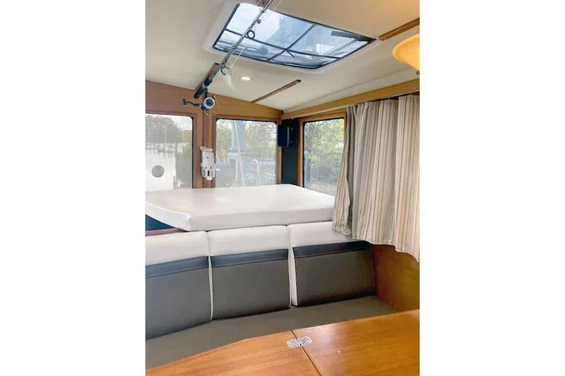 Slide: The Image of Interior of 2016 Ranger Tugs R-31 boat with seating and skylight. - 17