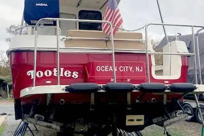 Slide: The Image of 2016 Ranger Tugs R-31 boat named "Tootles" in Ocean City, NJ, with American flag. - 2