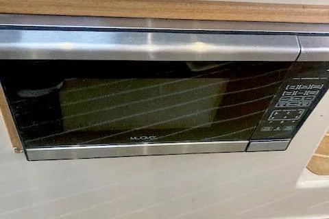 Slide: The Image of Microwave in 2016 Ranger Tugs R-31 boat interior, featuring control panel and wood trim. - 22