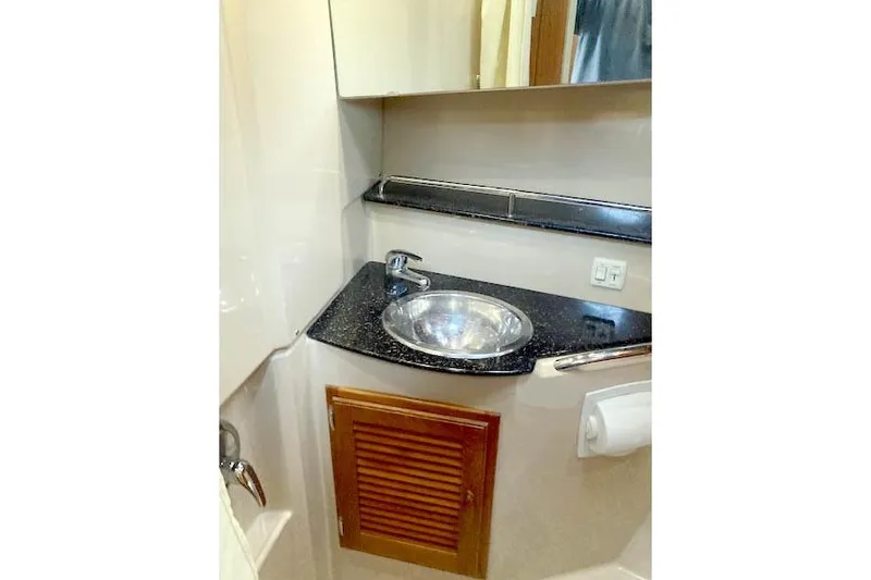 Slide: The Image of 2016 Ranger Tugs R-31 bathroom with sink, mirror, and storage cabinet. - 32