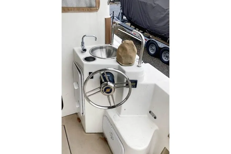 Slide: The Image of 2016 Ranger Tugs R-31 helm with sink and steering wheel. - 5