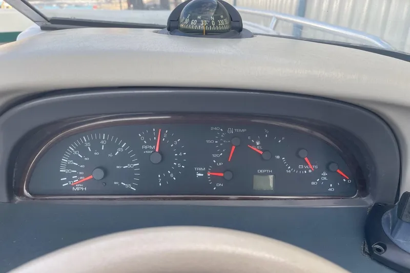 Slide: The Image of Dashboard of a 1996 Four Winns 200 Horizon boat with gauges and compass. - 10