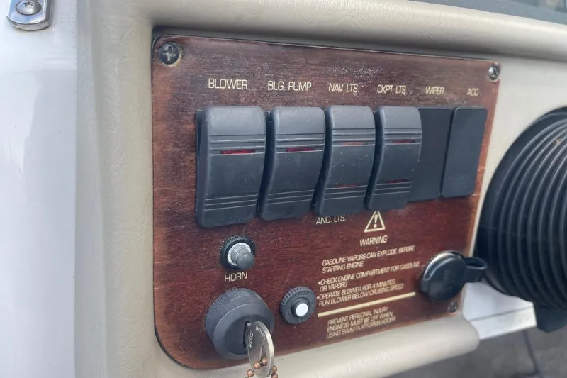 Slide: The Image of 1996 Four Winns 200 Horizon dashboard with switches and warning labels. - 11