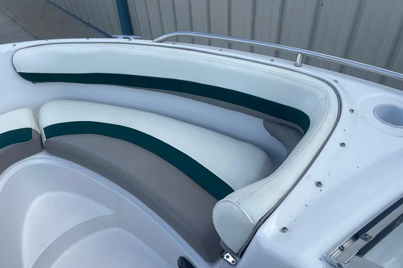 Slide: The Image of 1996 Four Winns 200 Horizon boat interior with white and green seating. - 14