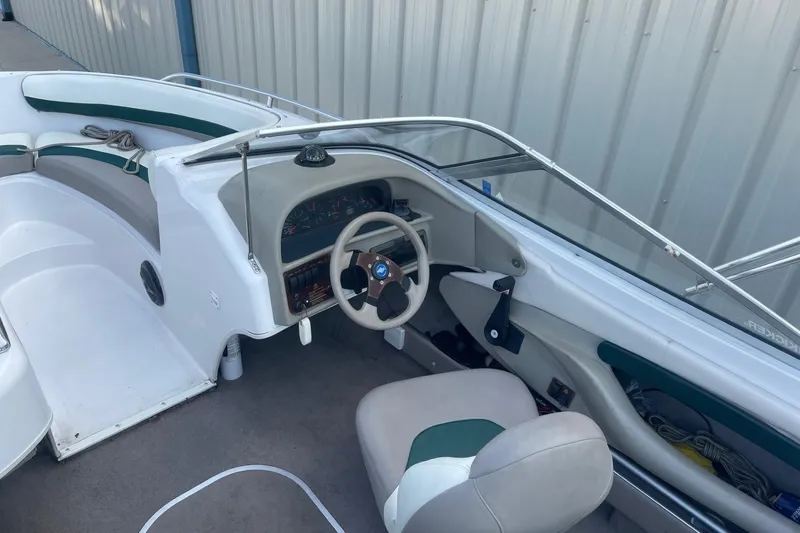 Slide: The Image of 1996 Four Winns 200 Horizon boat interior with steering wheel and seating. - 4