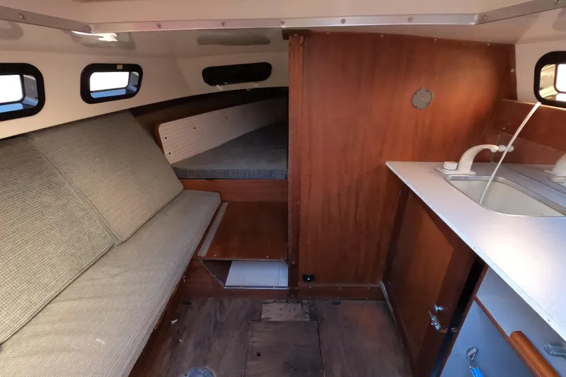 Slide: The Image of Interior of a 1986 Rhodes 22 sailboat with seating and kitchenette. - 6