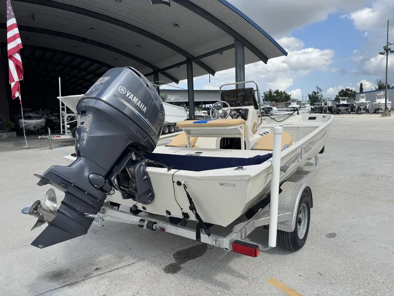 Slide: The Image of 2012 Xpress XP20CC boat with Yamaha outboard motor on trailer, parked outdoors. - 11
