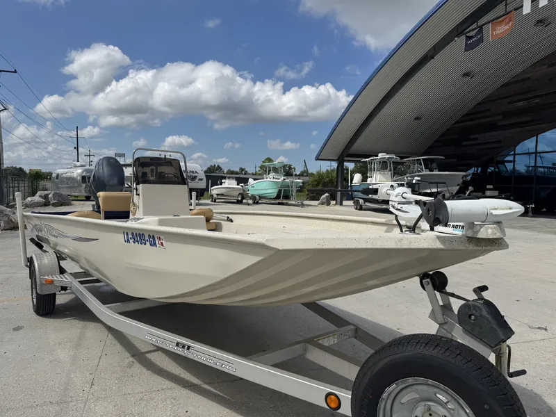 Slide: The Image of 2012 Xpress XP20CC boat on trailer, parked outside a showroom under a blue sky. - 12