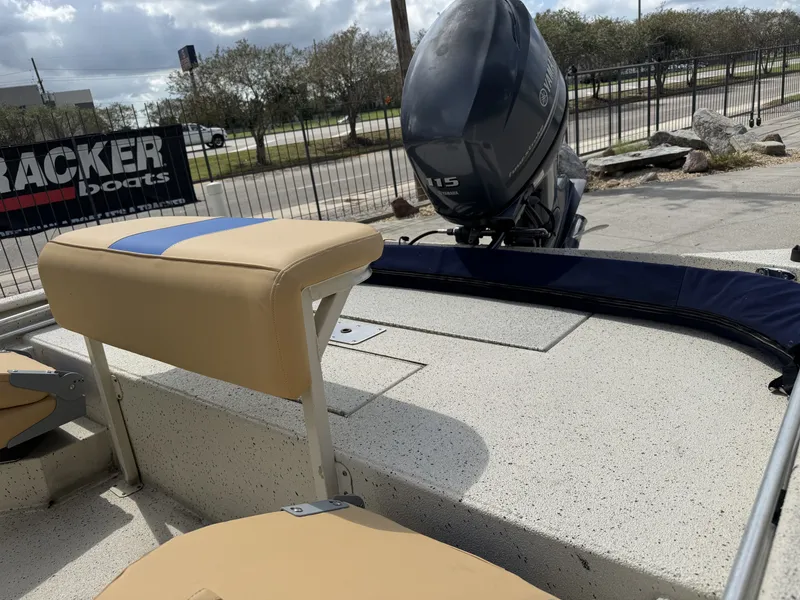 Slide: The Image of 2012 Xpress XP20CC boat with Yamaha 115 engine, beige seating, and outdoor setting. - 15