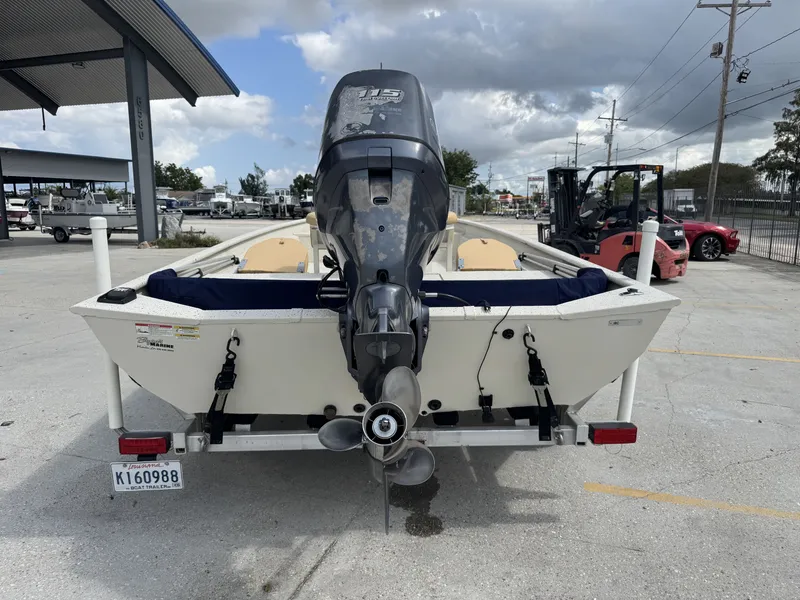 Slide: The Image of 2012 Xpress XP20CC boat with outboard motor on trailer, parked outdoors. - 3
