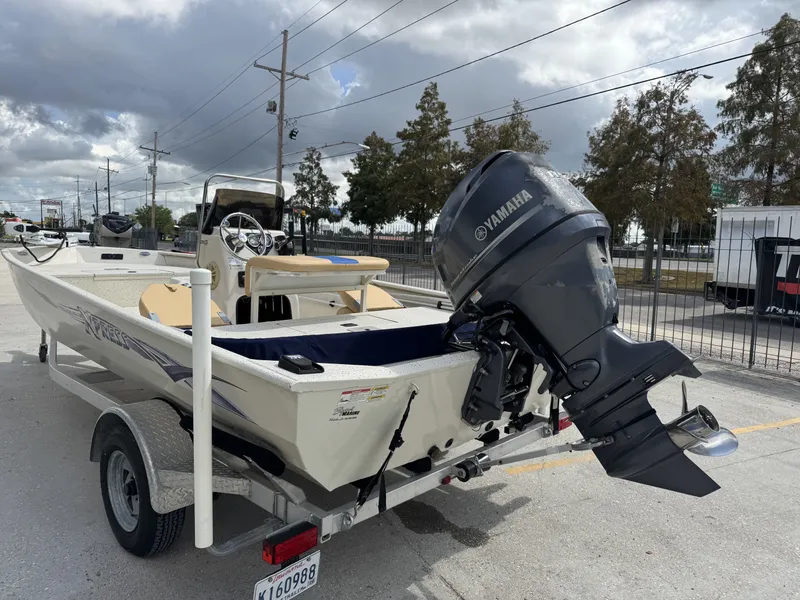 Slide: The Image of 2012 Xpress XP20CC boat with Yamaha outboard motor on trailer, parked outdoors. - 4