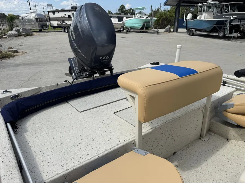 Slide: The Image of 2012 Xpress XP20CC boat with Yamaha 115 engine, beige seating, parked outdoors. - 9
