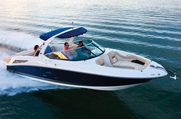The Image of 2010 Sea Ray 300 SLX boat docked at a marina with lush green trees. - 0