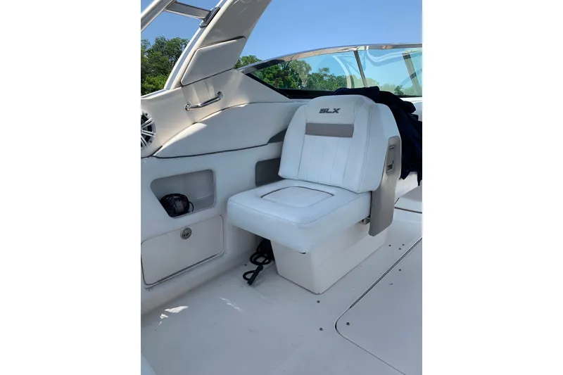 Slide: The Image of 2010 Sea Ray 300 SLX boat interior with white seating and storage compartments. - 10