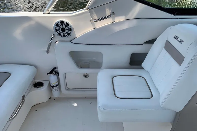 Slide: The Image of Interior of 2010 Sea Ray 300 SLX boat with white seating and speaker. - 11