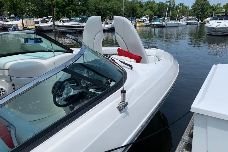 Slide: The Image of 2010 Sea Ray 300 SLX boat docked at marina, featuring sleek design and modern interior. - 12