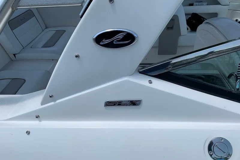 Slide: The Image of 2010 Sea Ray 300 SLX boat interior with logo and seating detail. - 13