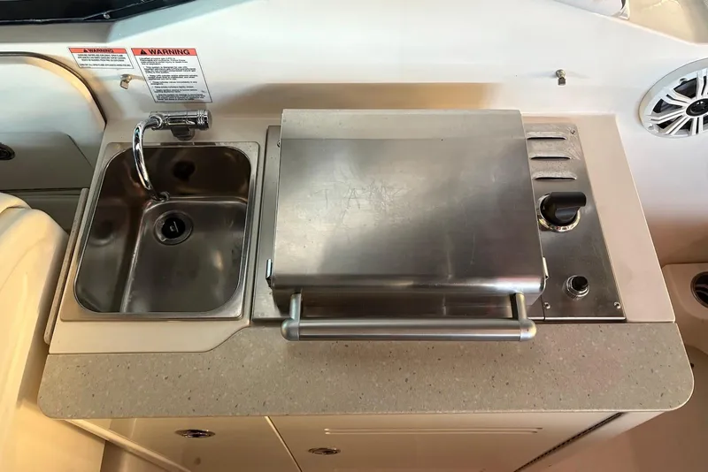 Slide: The Image of 2010 Sea Ray 300 SLX boat kitchenette with sink and grill. - 16