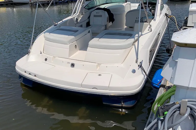Slide: The Image of 2010 Sea Ray 300 SLX boat docked on calm water, rear view. - 19