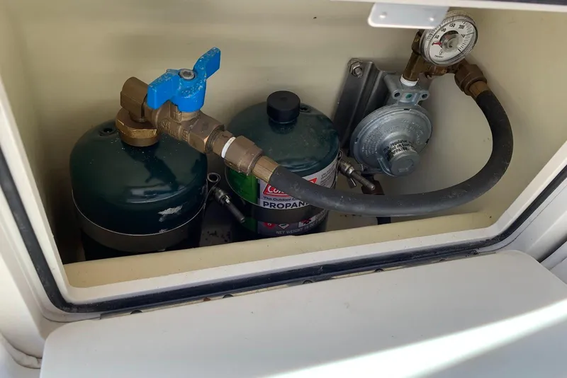 Slide: The Image of Propane tank compartment in 2010 Sea Ray 300 SLX boat with gauge and valve. - 23