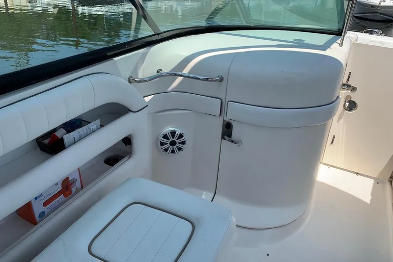 Slide: The Image of Interior of 2010 Sea Ray 300 SLX boat with white seating and storage compartments. - 8
