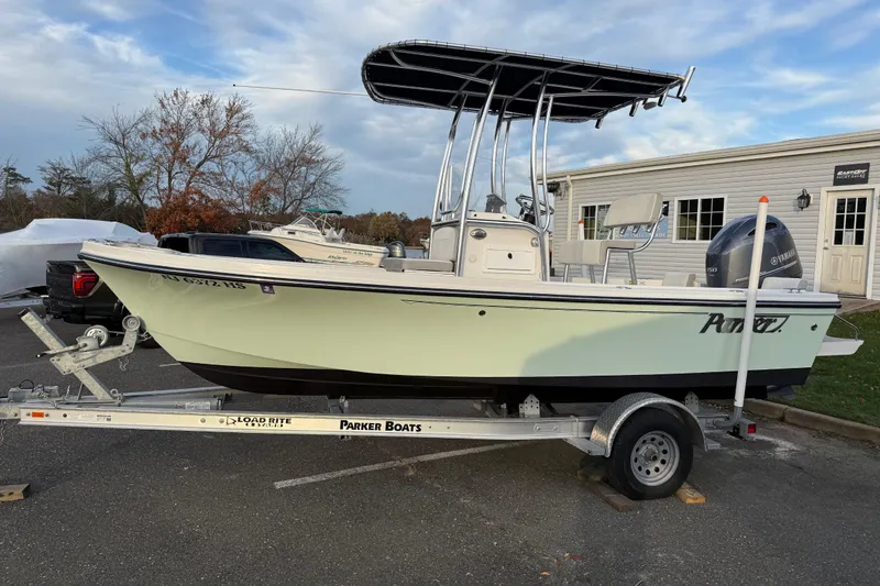 The Image of 2024 Parker 1801 Center Console boat on trailer, parked outdoors near dealership. - 1