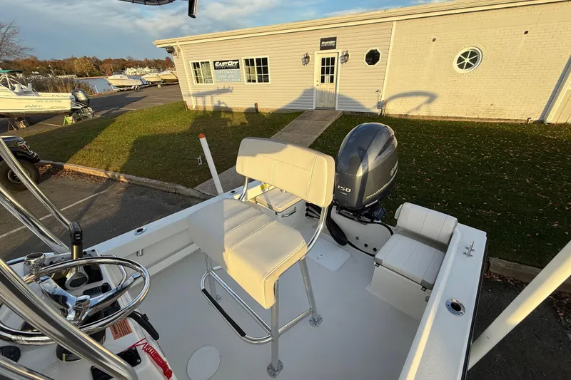 Slide: The Image of 2024 Parker 1801 Center Console boat with Yamaha 150 engine at a marina. - 11