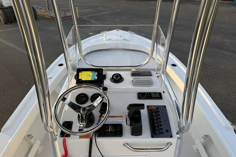 Slide: The Image of 2024 Parker 1801 Center Console boat interior with steering wheel and navigation equipment. - 12