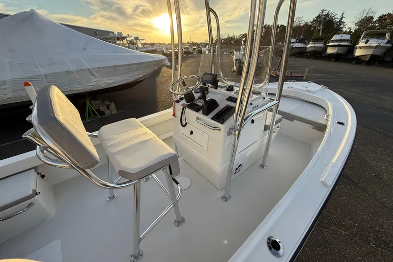 Slide: The Image of 2024 Parker 1801 Center Console boat interior at sunset, showcasing helm and seating. - 14
