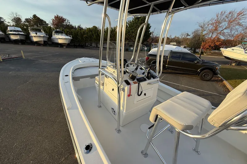 Slide: The Image of 2024 Parker 1801 Center Console boat with sleek design in a marina setting. - 15