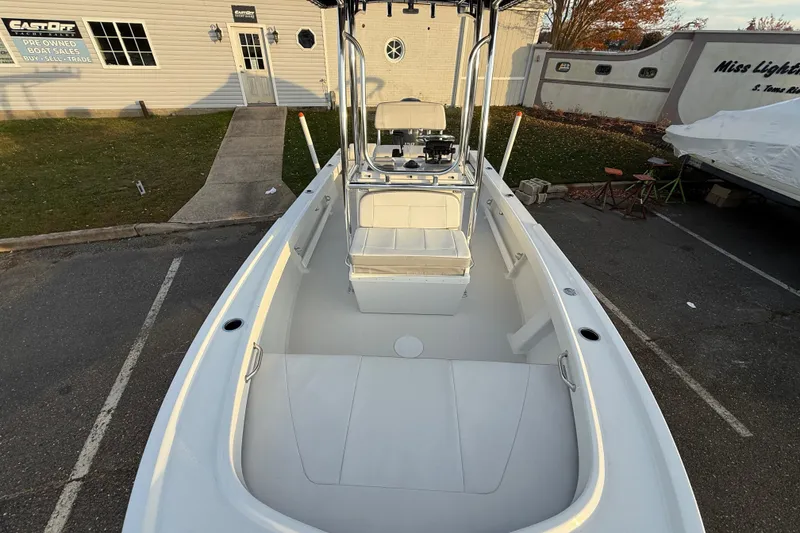 Slide: The Image of 2024 Parker 1801 Center Console boat at dealership, showcasing spacious deck and seating. - 19