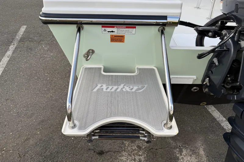 Slide: The Image of 2024 Parker 1801 Center Console boat swim platform with safety railings and logo. - 22