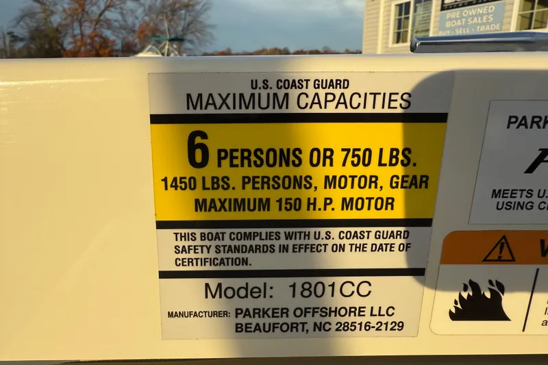 Slide: The Image of 2024 Parker 1801 Center Console boat capacity label, 6 persons or 750 lbs, 150 HP motor. - 26
