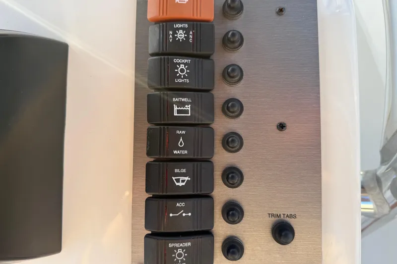 Slide: The Image of Control panel of 2024 Parker 1801 Center Console boat with labeled switches. - 33