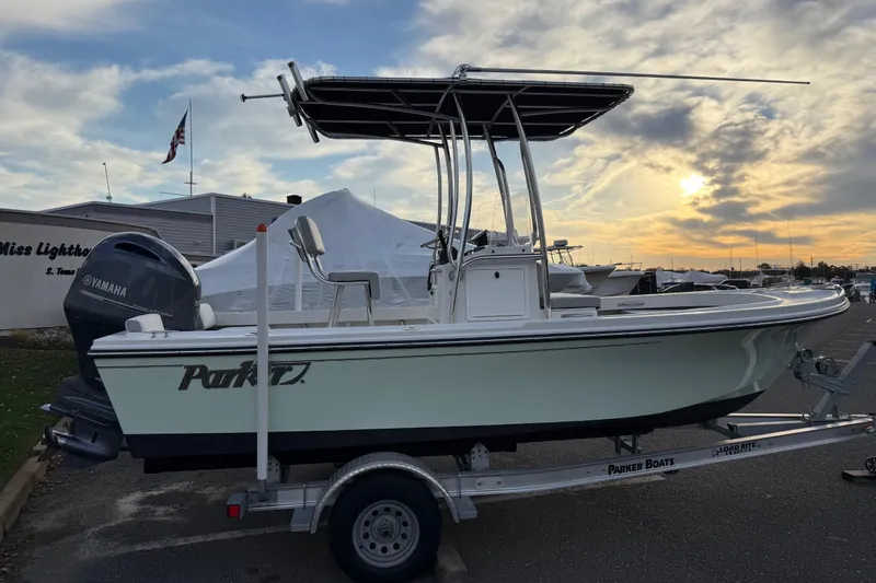Slide: The Image of 2024 Parker 1801 Center Console boat on trailer at sunset, featuring Yamaha engine. - 6