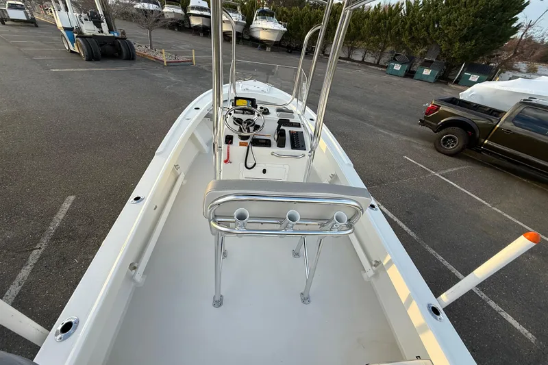 Slide: The Image of 2024 Parker 1801 Center Console boat in parking lot, showcasing helm and seating area. - 7