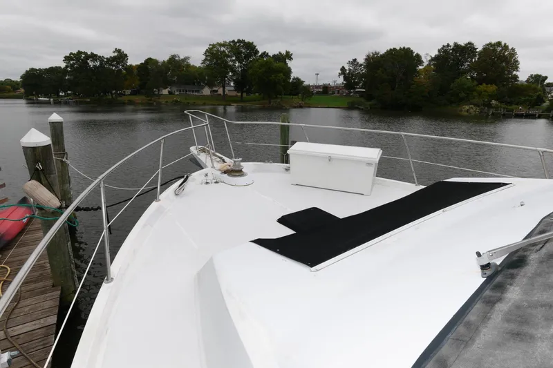 Slide: The Image of 1989 Viking 55 Widebody Motor Yacht on a calm river dock. - 11