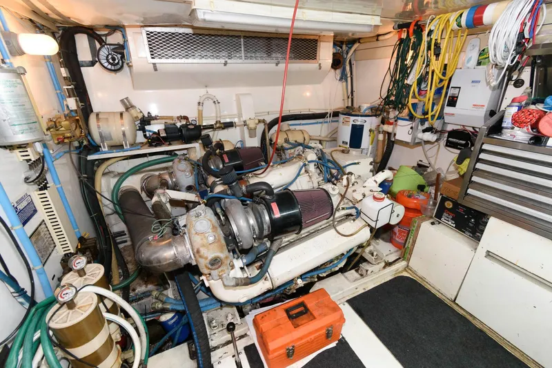 Slide: The Image of Engine room of 1989 Viking 55 Widebody Motor Yacht with tools and equipment. - 16