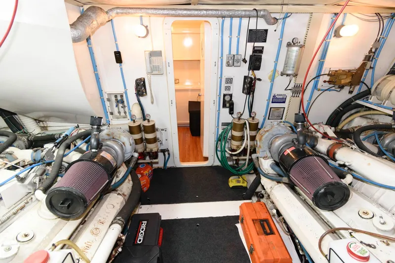 Slide: The Image of Engine room of 1989 Viking 55 Widebody Motor Yacht with visible machinery and equipment. - 17