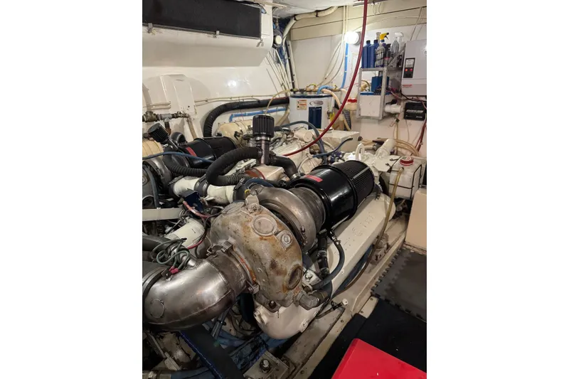 Slide: The Image of Engine room of 1989 Viking 55 Widebody Motor Yacht, showcasing mechanical components and equipment. - 21