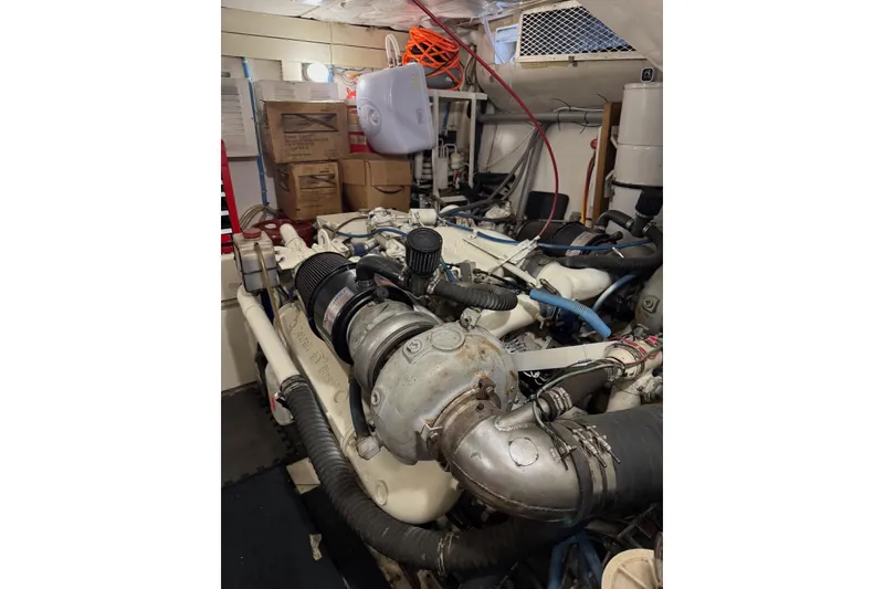 Slide: The Image of Engine room of 1989 Viking 55 Widebody Motor Yacht with visible machinery and storage. - 22