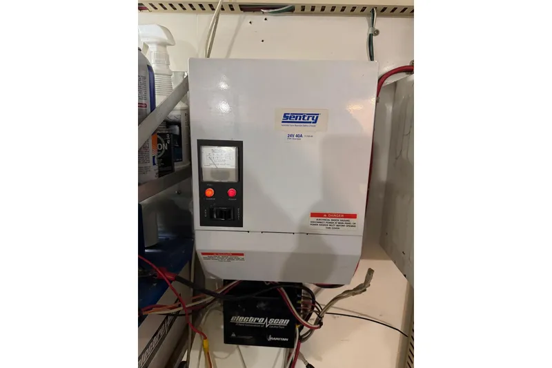 Slide: The Image of Electrical panel on 1989 Viking 55 Widebody Motor Yacht, featuring Sentry charger. - 24