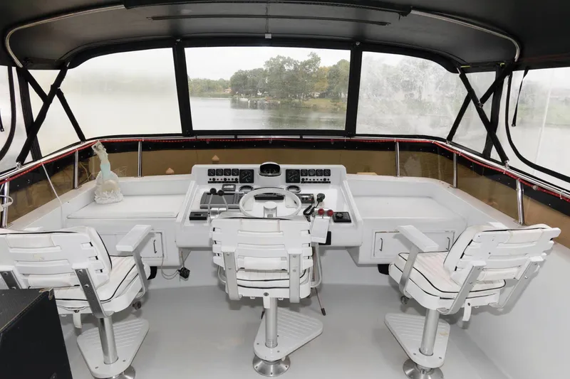 Slide: The Image of 1989 Viking 55 Widebody Motor Yacht with city skyline and marina view. - 3