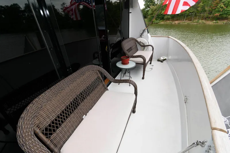 Slide: The Image of 1989 Viking 55 Widebody Motor Yacht helm with steering wheel and navigation controls. - 7