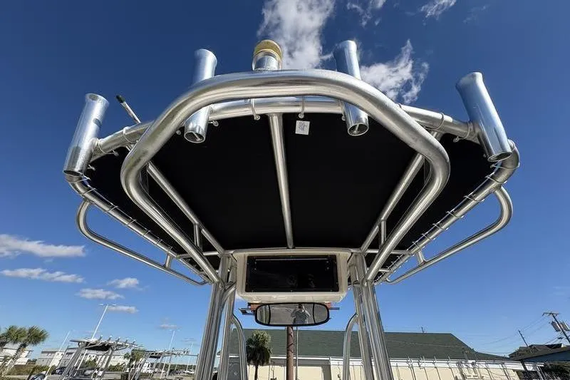 Slide: The Image of 2008 Edgewater 170CC boat T-top with rod holders against blue sky. - 11