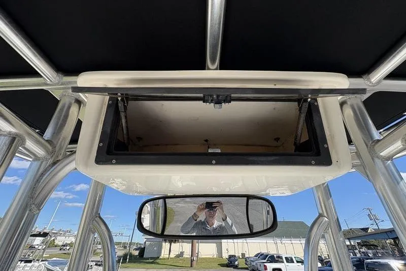 Slide: The Image of 2008 Edgewater 170CC boat console with open storage compartment and rearview mirror. - 12