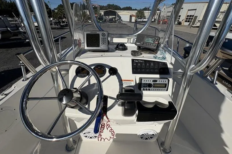 Slide: The Image of 2008 Edgewater 170CC boat console with steering wheel and navigation equipment. - 13